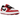 Jordan 1 Low Golf Spiked Varsity Red White Black sneakers i vinkelad vy med röd och vit läderöverdel samt svarta detaljer