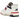 New Balance 550 Aime Leon Dore White Navy Red sneakers i vinklad profil med vit läderovandel, marinblå logotyp och röd detalj på yttersulan
