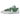 Nike Blazer Low sacai Medium Grey Classic Green sneakers i sidoprofil med grå ovandel i läder, gröna detaljer och dubbel staplad swoosh-logotyp.